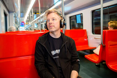 A man listening through headphones.