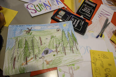 Children's drawings on the table.