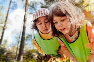 Two children in a forest environment.