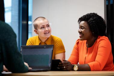 Two people at a desk.