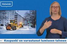 Lumiaura ja viittomakielinen uutisten lukija. Kuvakaappaus tammikuun viittomakilisistä uutisista Helsinki-kanavalta.